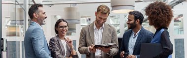 Businesspeople talking while standing in office during break. Teamwork concept. High quality photo