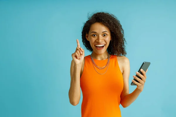 Smiling Woman Index Finger While Holding Mobile Phone Standing Blue — Stok Foto