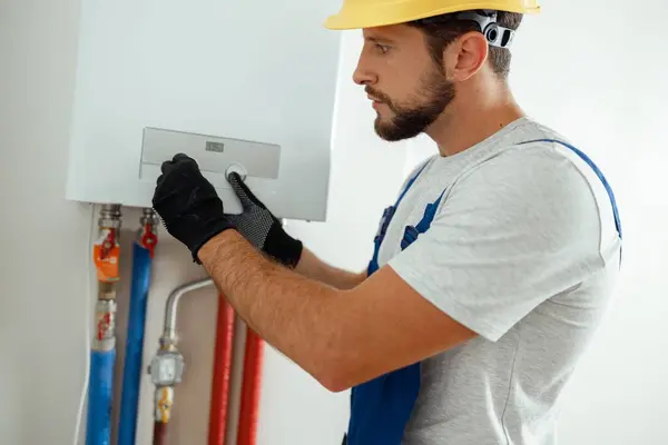 Serious Technician Setting New Gas Boiler Hot Water Heating Manual Stock Picture