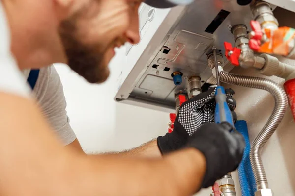 Closeup Plumber Using Screwdriver While Installing New Steel Hot Water Stock Image