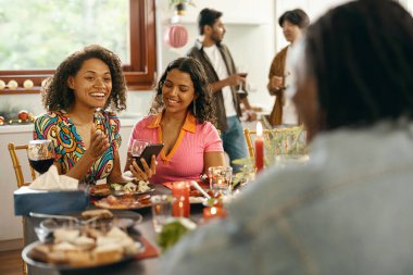 Olumlu arkadaşlar evde tatil partisinde şarap içip telefonla konuşuyorlar. Yüksek kalite fotoğraf