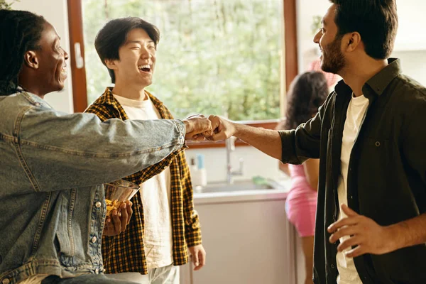 Happy friends giving high five greeting each other at home party. High quality photo