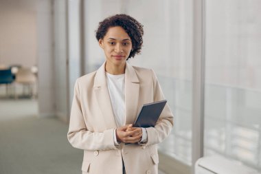 Modern çalışma arka planında dijital tabletli neşeli kadın serbest yazar 
