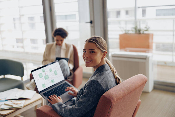 Happy Female Freelancer Working Laptop While Sitting Modern Coworking Looks Stock Photo