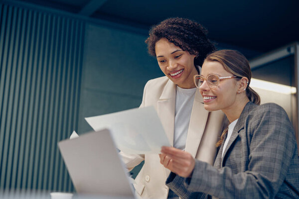 Two Female Professional Executives Experts Discussing Financial Accounting Papers Working Stock Photo