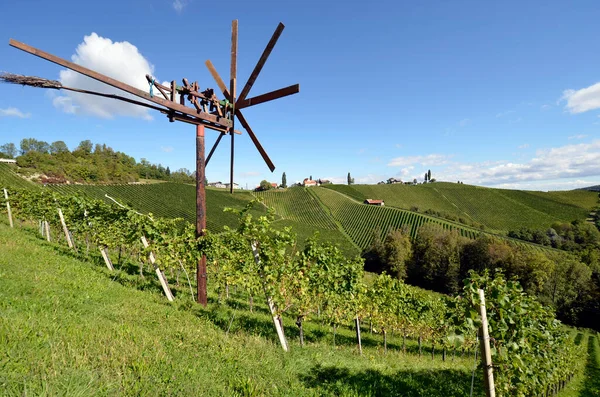 stock image Austria, traditional Klapotez scarecrow and vineyards on the steep slopes located on the Styrian wine route, the hilly landscape is also known as the Tuscany of Austria, Klapotetz are used in south-eastern Austria by their clatter they drive the bird