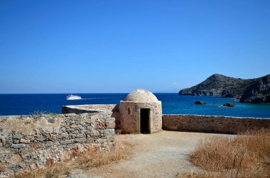 Greece, Crete, buildings built of stone in old Venetian Fortress Spinalonga, until 1957 used as a leper station, now a popular tourist destination, view to Kalydon peninsula