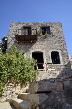 Greece, Crete, home with balcony built of stone in old Venetian Fortress Spinalonga, until 1957 used as a leper station, now a popular tourist destination