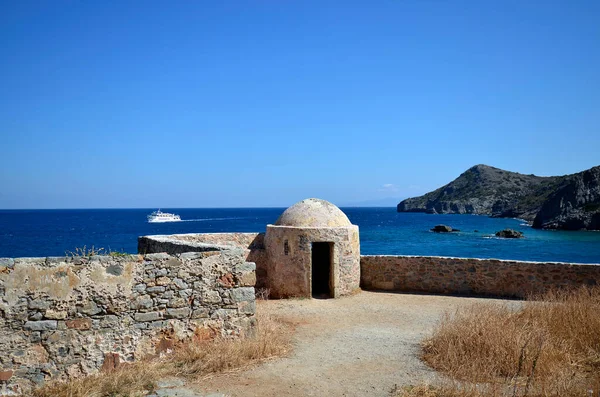 Greece, Crete, buildings built of stone in old Venetian Fortress Spinalonga, until 1957 used as a leper station, now a popular tourist destination, view to Kalydon peninsula