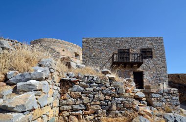 Greece, Crete, home with balcony built of stone in old Venetian Fortress Spinalonga, until 1957 used as a leper station, now a popular tourist destination