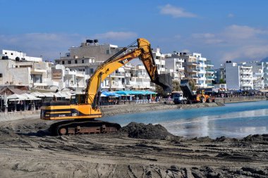 Ierapatra, Crete, Greece - October 12, 2022: Excavators and trucks during excavation work at the port of Europe's southernmost city on the Libyan Sea