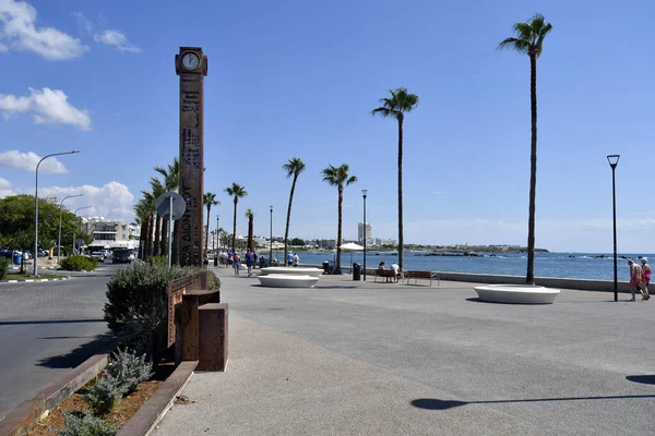 stock image Paphos, Cyprus - October 02, 2023: Paphos Clock and unidentified people on promenade along Mediterranean Sea in the former European Capital of Culture 2017;