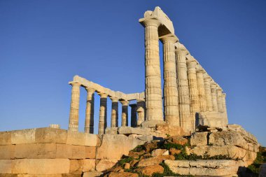 Lavrio, Greece - December 19, 2023: The ancient Temple of Poseidon in the light of the setting sun clipart