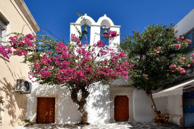 Parikia, Greece - September 17, 2024: Tiny church with bell tower in the picturesque town of Parikia clipart