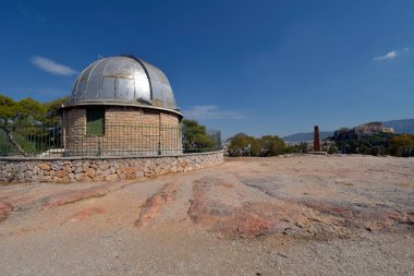 Athens, Greece - September 24, 2024: Unidentified tourists on Filopappos Hill with observatory, obelisk and view to Acropolis clipart