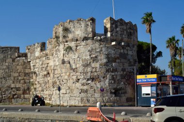 Cos, Greece - September 04, 2025: Fortified wall with battlements of the old castle at the harbor of Cos City