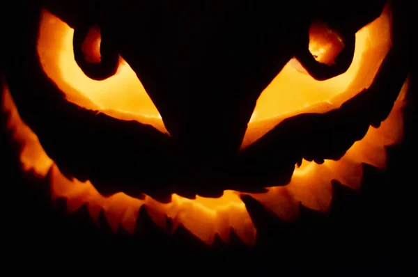 stock image Close up shot of scary candle lit pumpkin face