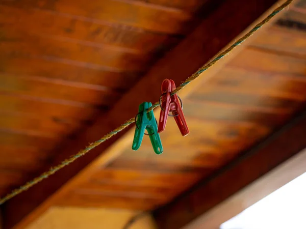 Laundry Hooks Hung on a Rope with Wooden Ceiling Backing