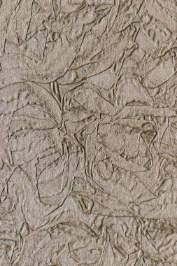 Kahverengi kabartmalı batik deseni. Çiçek deseni. Yaprak damgalı doku. Duvar kağıdı arkaplanı