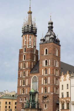 Bu yüksek çözünürlüklü resim Polonya 'nın Krakow kentindeki St. Marys Bazilikası' nın ikonik kulelerini gösteriyor. Kırmızı tuğla cephesi, gotik detaylar, ve asırlık kulelerin altını çizmek