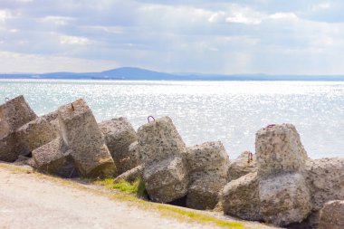 large shaped stones on a pier by the sea. nature, landscape, background