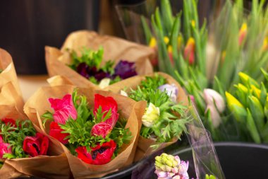 bouquets of spring flowers in a wrapper in a florist shop