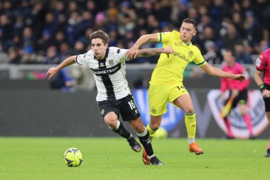 Adrian Bernabe of PARMA CALCIO competes for the ball with Kristjan Asllani of INTER during Italian football Coppa Italia match Inter - FC Internazionale vs Parma Calcio at the  San Siro stadium in Milan, Italy, January 10, 2023 - Credit: Luca Amedeo 