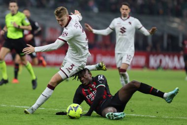 Rafael Leao of AC Milan competes for the ball with Perr Schuurs of Torino FC during Coppa Italia 2022/23 football match between AC Milan and Torino FC at San Siro Stadium, Milan, Italy on January 11, 2023 - Credit: Fabrizio Carabelli/LiveMedi