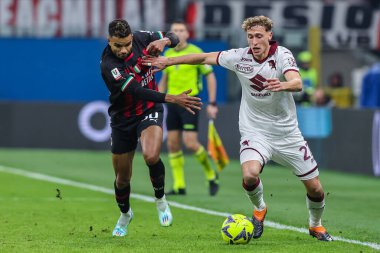 Mergim Vojvoda of Torino FC competes for the ball with Junior Messias of AC Milan during Coppa Italia 2022/23 football match between AC Milan and Torino FC at San Siro Stadium, Milan, Italy on January 11, 2023 - Credit: Fabrizio Carabelli/LiveMedi