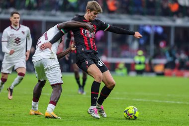 Charles De Ketelaere of AC Milan competes for the ball with Ndary Adopo of Torino FC during Coppa Italia 2022/23 football match between AC Milan and Torino FC at San Siro Stadium, Milan, Italy on January 11, 2023 - Credit: Fabrizio Carabelli/LiveMedi