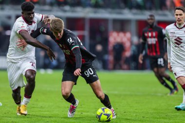 Charles De Ketelaere of AC Milan competes for the ball with Ndary Adopo of Torino FC during Coppa Italia 2022/23 football match between AC Milan and Torino FC at San Siro Stadium, Milan, Italy on January 11, 2023 - Credit: Fabrizio Carabelli/LiveMedi