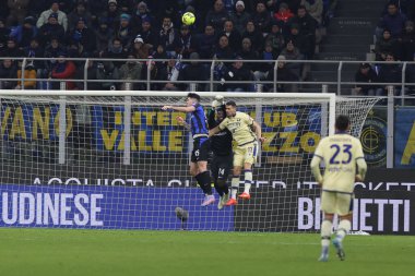 Andre Onana of FC Internazionale competes for the ball with Kevin Lasagna of Hellas Verona FC and Alessandro Bastoni of FC Internazionale during Serie A 2022/23 football match between FC Internazionale and Hellas Verona FC at Giuseppe Meazza Stadium,