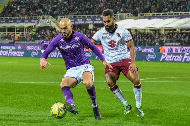 Fiorentina's Riccardo Saponara hampered by Torino's Koffi Djidji during italian soccer Serie A match ACF Fiorentina vs Torino FC at the Artemio Franchi stadium in Florence, Italy, January 21, 2023 - Credit: Fabio Fagiolin