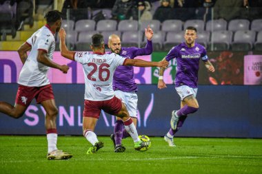 Torino's Koffi Djidji fights for the ball against Fiorentina's Riccardo Saponara during italian soccer Serie A match ACF Fiorentina vs Torino FC at the Artemio Franchi stadium in Florence, Italy, January 21, 2023 - Credit: Fabio Fagiolin