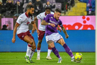 Fiorentina's Cristiano Biraghi hampered by Torino's Koffi Djidji during italian soccer Serie A match ACF Fiorentina vs Torino FC at the Artemio Franchi stadium in Florence, Italy, January 21, 2023 - Credit: Fabio Fagiolin