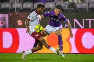 Fiorentina's Cristiano Biraghi fights for the ball against Torino's Singo Wilfried during italian soccer Serie A match ACF Fiorentina vs Torino FC at the Artemio Franchi stadium in Florence, Italy, January 21, 2023 - Credit: Fabio Fagiolin