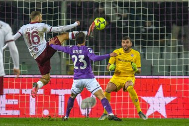 Torino's Nikola Vlasic in acrobatic tackle against Fiorentina's Lorenzo Venuti during italian soccer Serie A match ACF Fiorentina vs Torino FC at the Artemio Franchi stadium in Florence, Italy, January 21, 2023 - Credit: Fabio Fagiolin