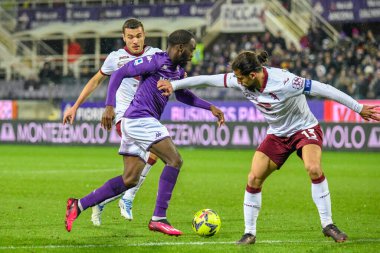 Fiorentina's Jonathan Ikone hampered by Torino's Ricardo Rodriguez and Torino's Alessandro Buongiorno during italian soccer Serie A match ACF Fiorentina vs Torino FC at the Artemio Franchi stadium in Florence, Italy, January 21, 2023 - Credit: Fabio 
