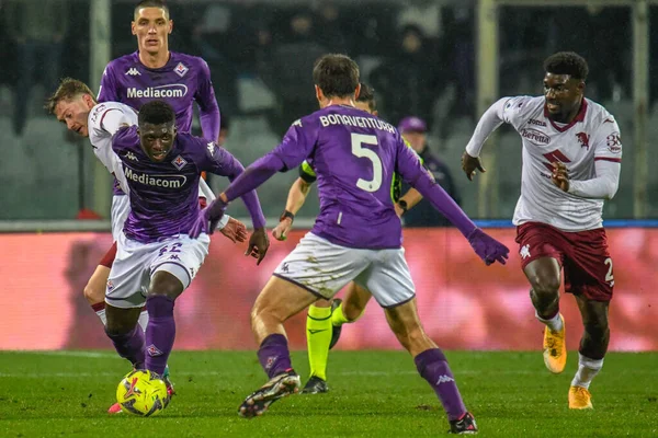 Fiorentina's Alfred Duncan hampered by Torino's Nikola Vlasic and Torino's Demba Seck during italian soccer Serie A match ACF Fiorentina vs Torino FC at the Artemio Franchi stadium in Florence, Italy, January 21, 2023 - Credit: Fabio Fagiolin