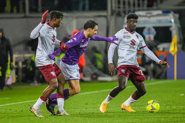 Torino's Michel Adopo hampered by Fiorentina's Giacomo Bonaventura during italian soccer Serie A match ACF Fiorentina vs Torino FC at the Artemio Franchi stadium in Florence, Italy, January 21, 2023 - Credit: Fabio Fagiolin