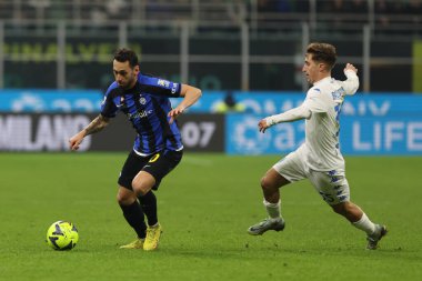 Hakan Calhanoglu of FC Internazionale competes for the ball with Tommaso Baldanzi of Empoli FC during Serie A 2022/23 football match between FC Internazionale and Empoli FC at Giuseppe Meazza Stadium, Milan, Italy on January 23, 2023 - Credit: Fabriz