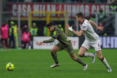 Brahim Diaz of AC Milan competes for the ball with Alessandro Buongiorno of Torino FC during Serie A 2022/23 football match between AC Milan and Torino FC at San Siro Stadium, Milan, Italy on February 10, 2023 - Credit: Fabrizio Carabelli/LiveMedi