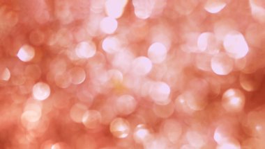 Şenlikli parıltı bulanık kırmızı arka planda bokeh ve röfleler.