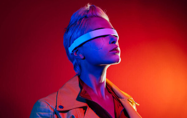 Representation of a bionic super human with advanced technology parts as vr visors and gadgets playing in a mixed reality training room. Futuristic cyberpunk evolution of human mankind and AI