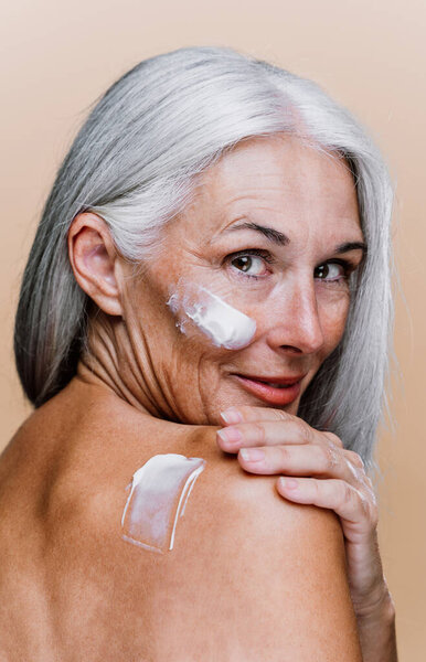Image of a beautiful senior woman posing on a beauty photo session. Middle aged woman on a colored background. Concept about body positivity, self esteem and body acceptance