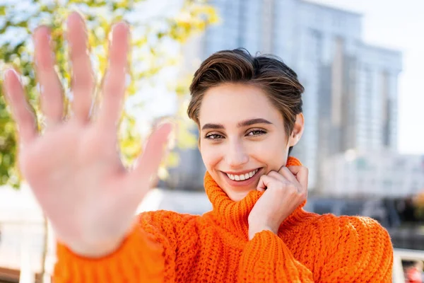 Beautiful young woman with short hair in the city - Pretty caucasian female adult business woman wearing winter sweater