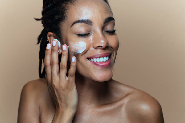 Beautiful woman making skin and facial beauty treatments. Studio shot with focus on cosmetic and skin care concepts