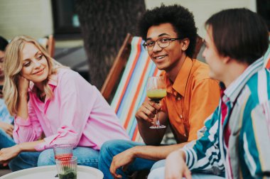 Multiracial young people together meeting and having party in a restaurant - Group of friends with mixed races having fun celebrating in a bar- Friendship and lifestyle concepts