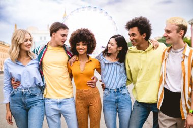 Multiracial young people together meeting and social gathering - Group of friends with mixed races having fun outdoors in the city- Friendship and lifestyle concepts