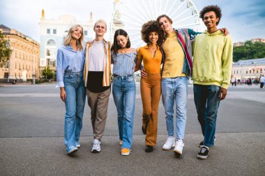 Multiracial young people together meeting and social gathering - Group of friends with mixed races having fun outdoors in the city- Friendship and lifestyle concepts